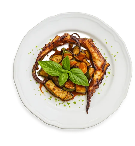 Assiette de pâtes italiennes avec légumes grillés et basilic frais servie chez Tivoli