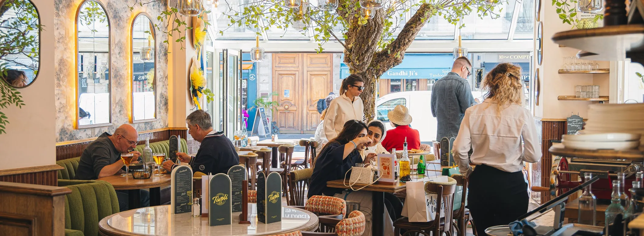Terrasse du restaurant Tivoli avec clients attablés et décor végétal